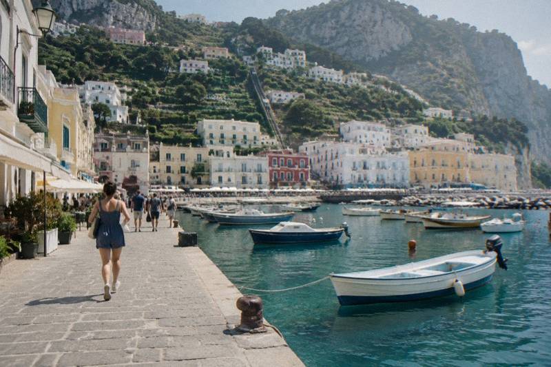 The small harbour of Marina Grande on Capri with pastel houses on the hill