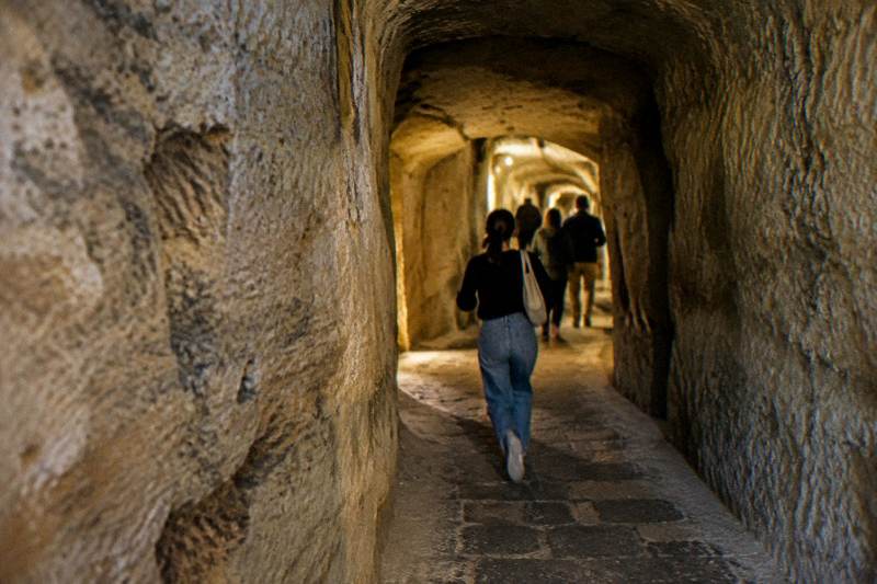 A small group in a tuff-stone tunnel under Naples