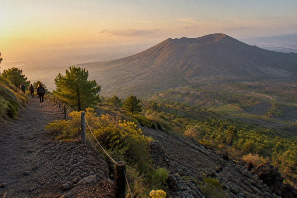 The barren upper slopes and crater rim of Mount Vesuvius under a clear sky
