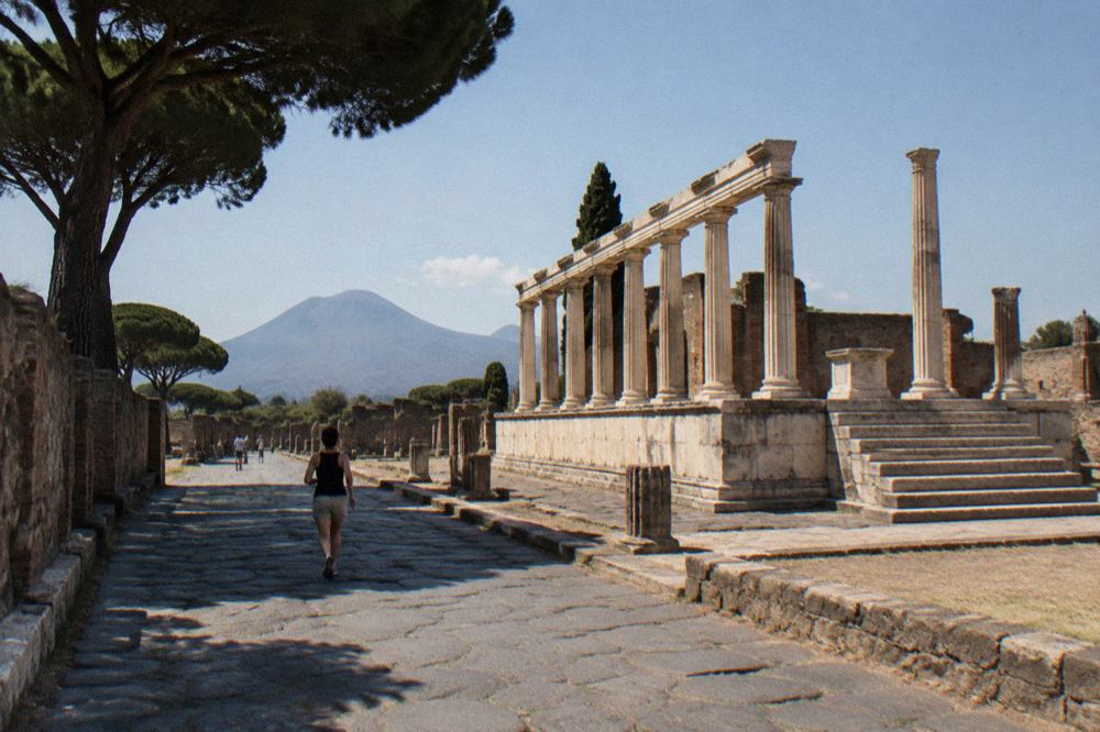 A stone-paved ancient Roman street in Pompeii with deep worn ruts and raised stepping stones