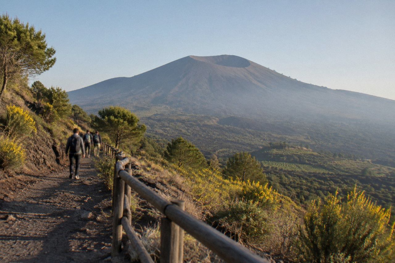 A stone path climbing the slopes of Mount Vesuvius toward the crater rim