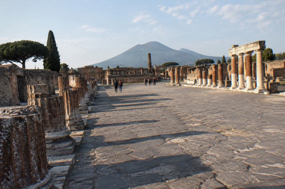 The crater rim of Mount Vesuvius under a clear sky above the Bay of Naples