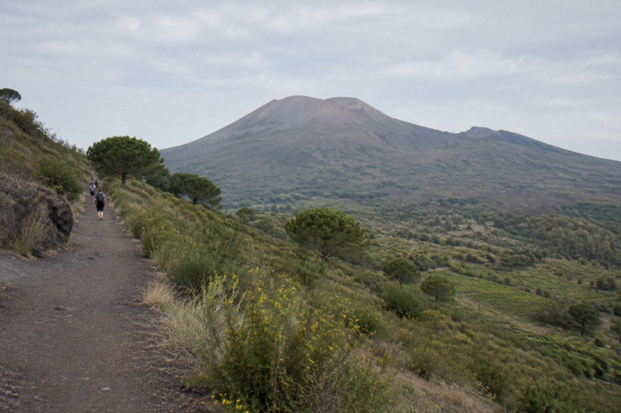 The crater rim of Mount Vesuvius under a clear sky above the Bay of Naples