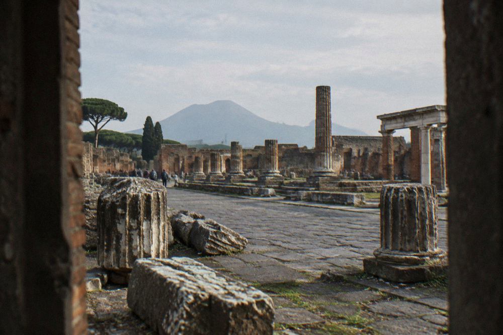 Ancient stone doorway of a Roman house in Pompeii with worn steps under daylight