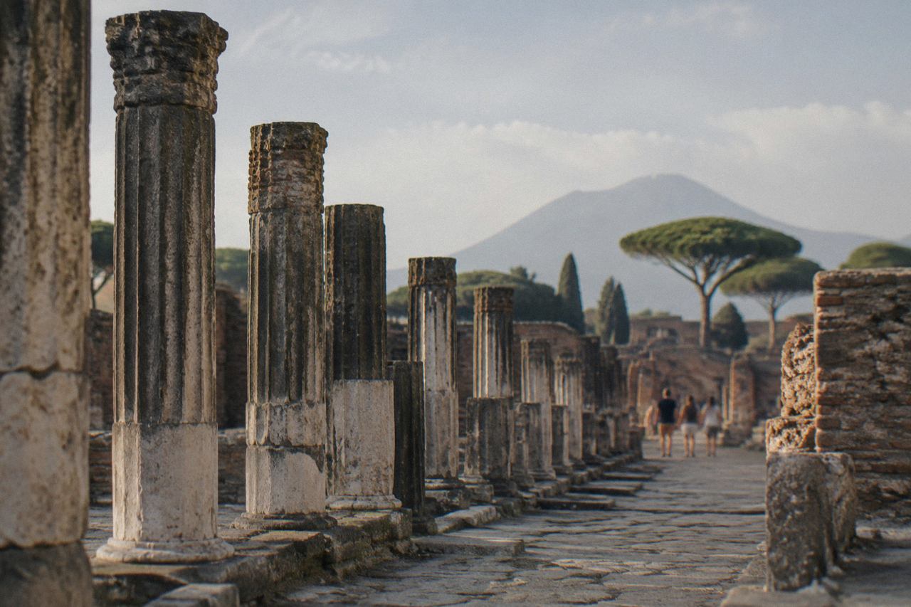 Ancient stone doorway of a Roman house in Pompeii with worn steps under daylight