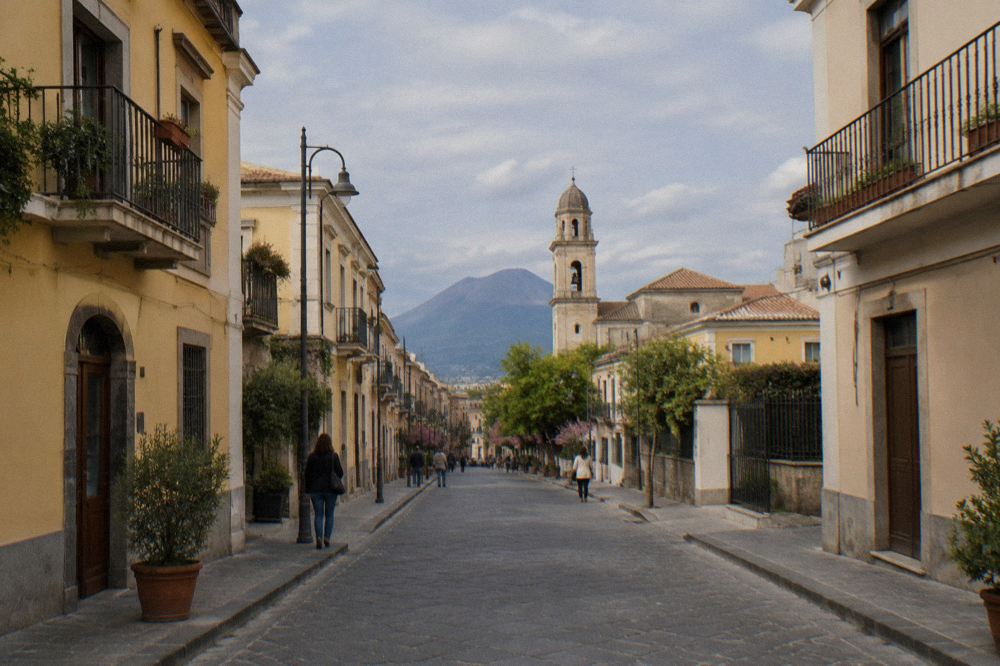 A quiet evening street in the modern town of Pompei with the sanctuary dome visible above the rooftops