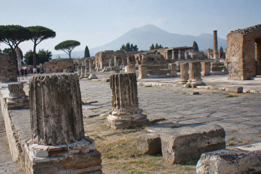 Ancient stone-paved street in Pompeii with worn stepping stones under open sky