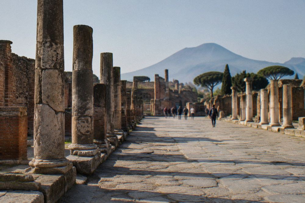 A line of coaches and cars parked in a lot near the amphitheatre end of the Pompeii site
