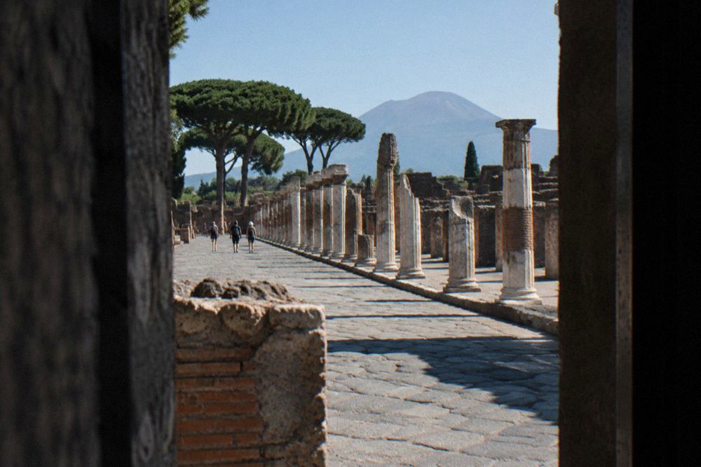 The summit crater of Mount Vesuvius seen from the upper path, with the Bay of Naples haze beyond