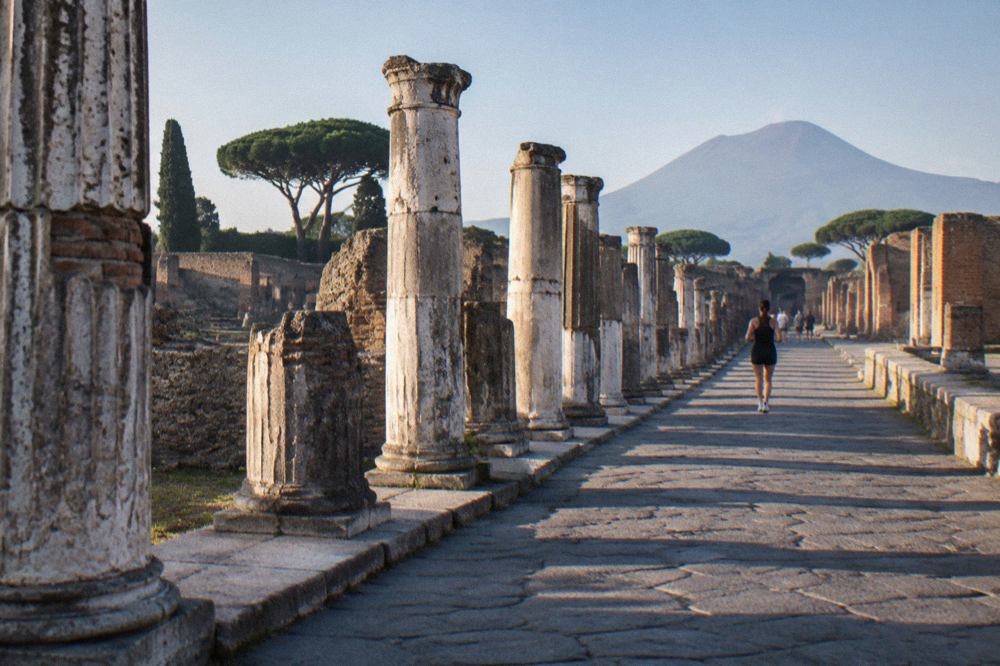 Ancient stone street in the ruins of Pompeii under a low afternoon sky