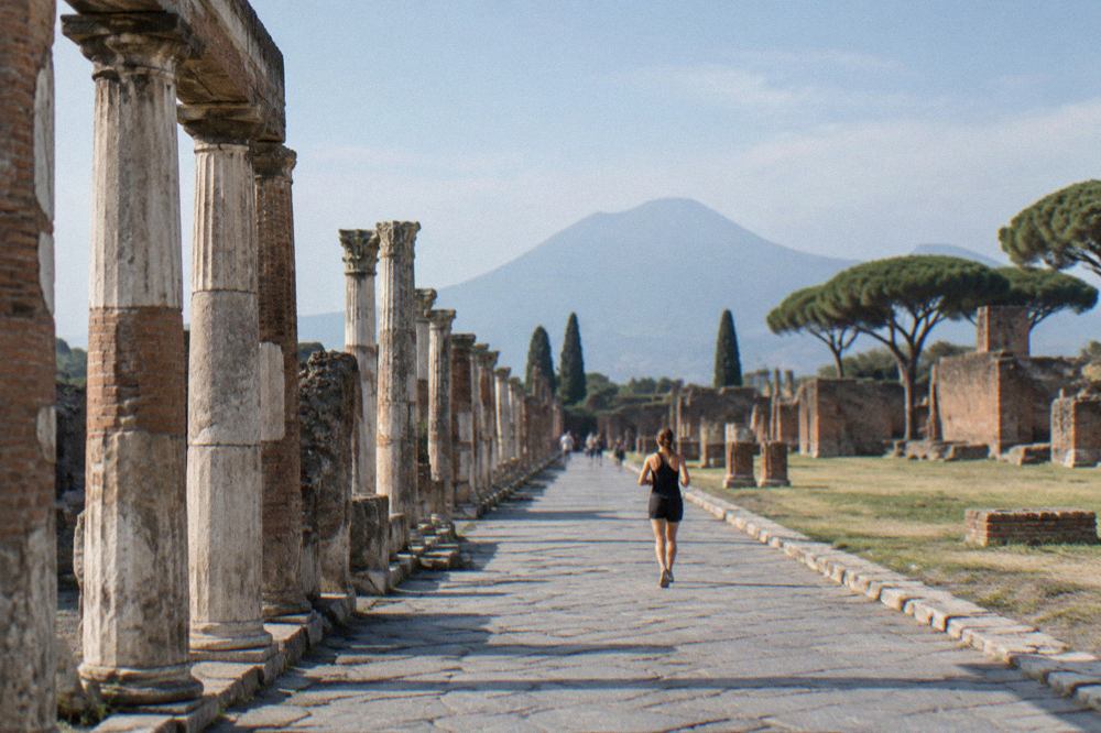 Ancient stone street in Pompeii with Mount Vesuvius rising in the background