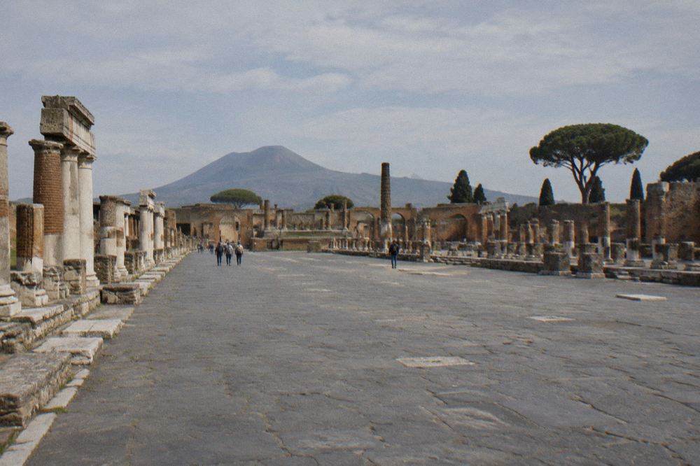 Modern rooftops of Pompei seen beyond the ancient walls of the archaeological park