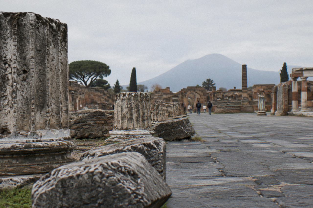 Ancient stone street in Pompeii with Mount Vesuvius rising in the background