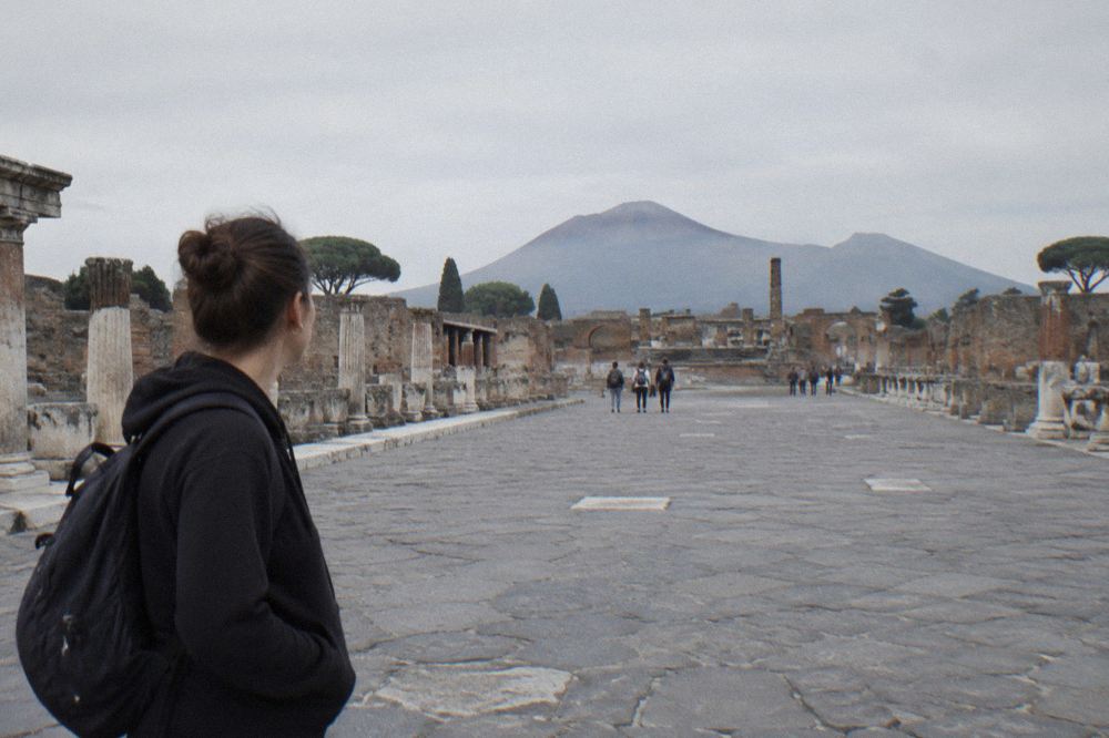 Weathered stone wall in Pompeii with traces of ancient painted lettering