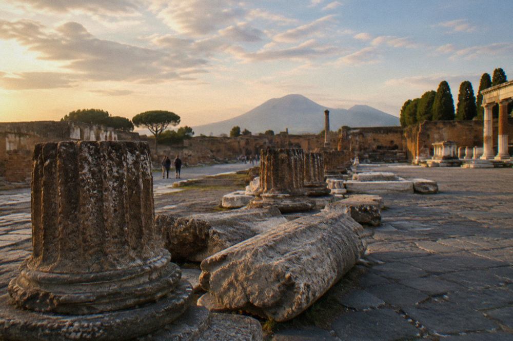 Ancient stone street in the Pompeii archaeological park with Mount Vesuvius on the horizon