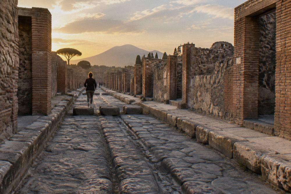 The ancient street and stone doorway of a Roman house at the Pompeii archaeological park