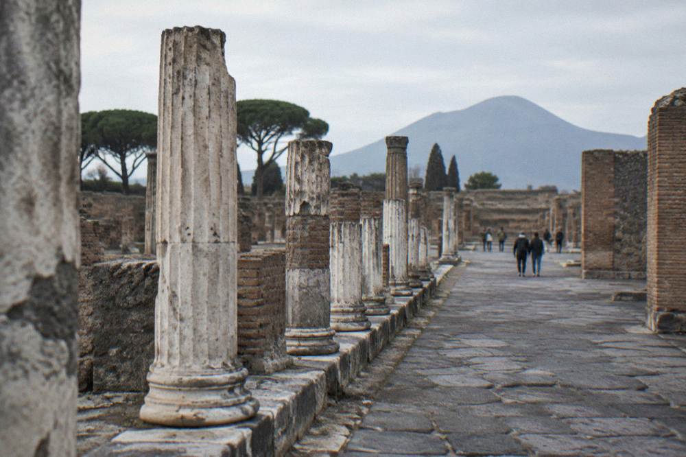 Empty ancient stone streets and ruined walls of Pompeii under a clear sky