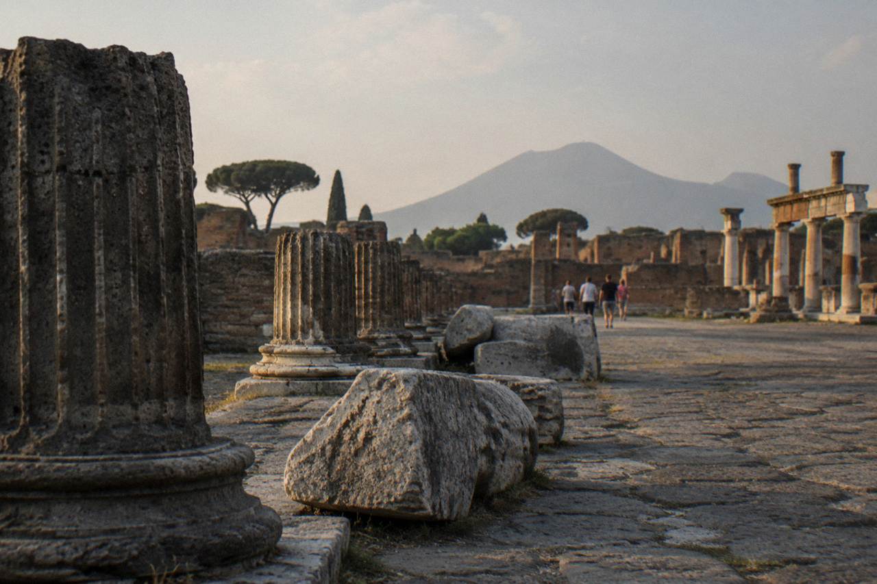 Empty ancient stone streets and ruined walls of Pompeii under a clear sky