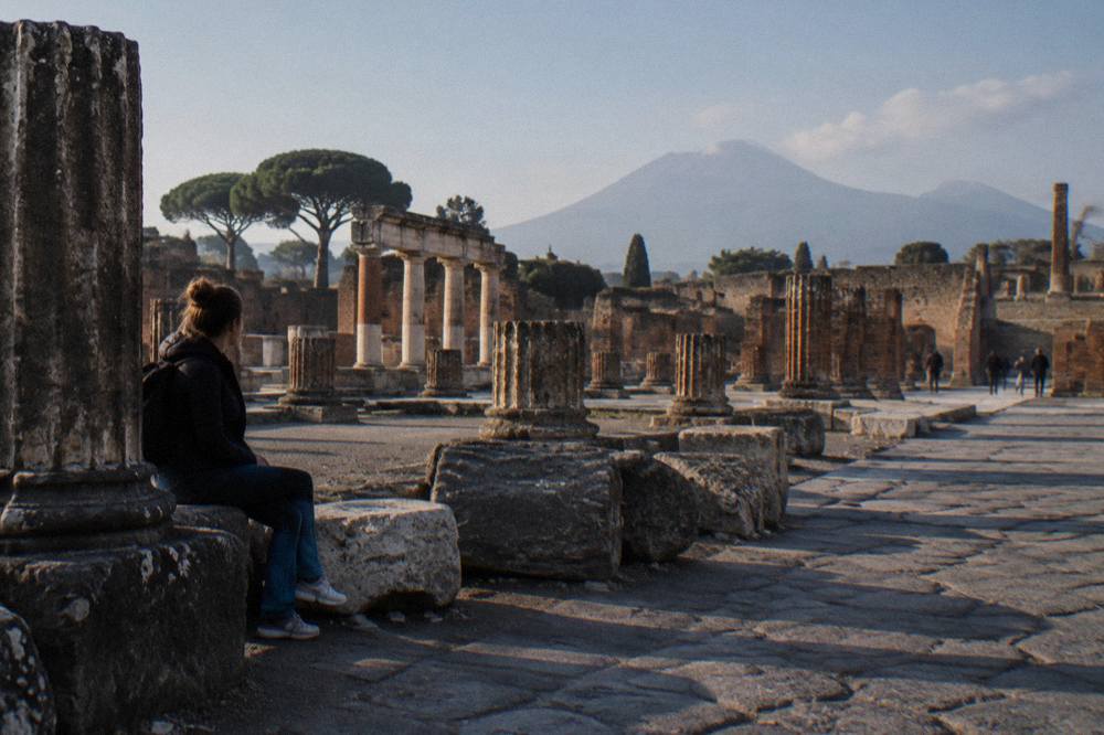 The rim of the Vesuvius summit crater with the Bay of Naples and the plain of Pompei in the distance