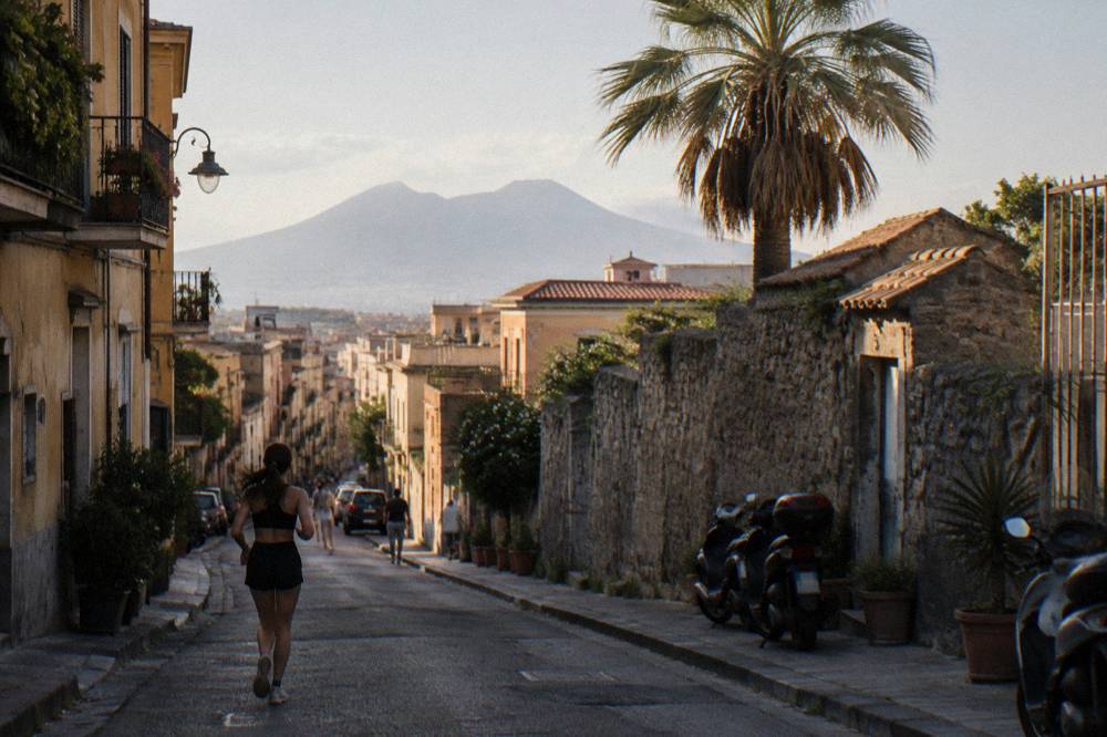 Narrow ancient street in Herculaneum lined with stone walls and doorways