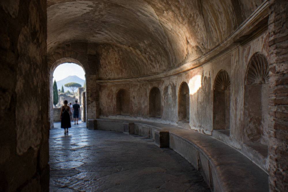 Sunlit stone ruins seen from a terrace above the Herculaneum site