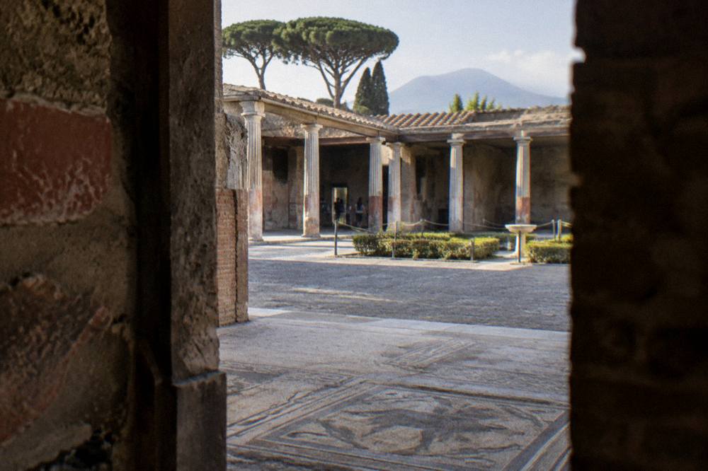 Wide view of the excavated Herculaneum site surrounded by modern apartment buildings
