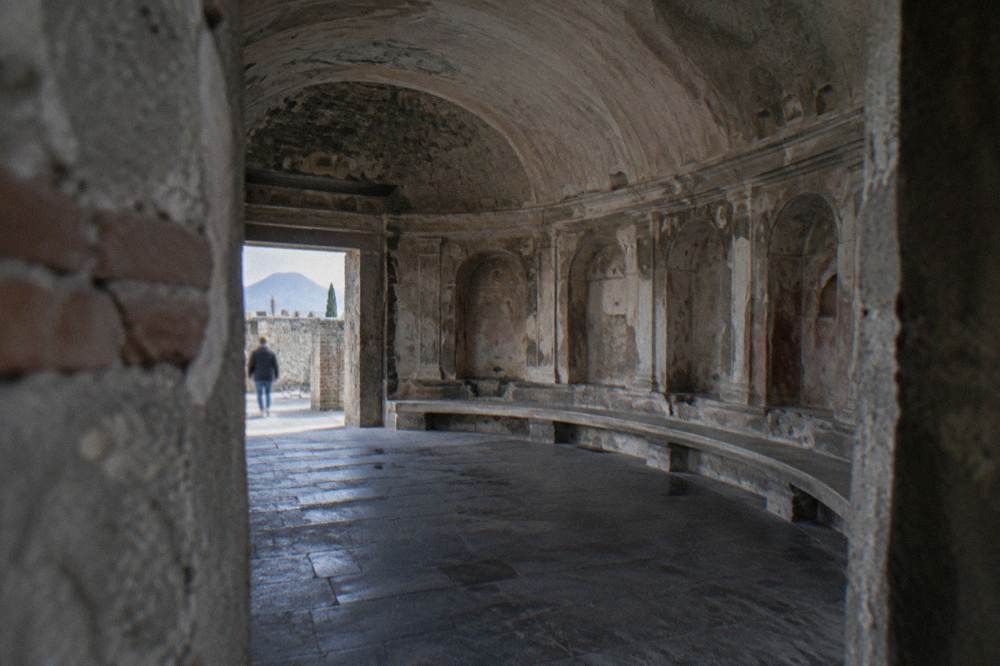 The Forum colonnade of Pompeii with the silhouette of Vesuvius on the horizon