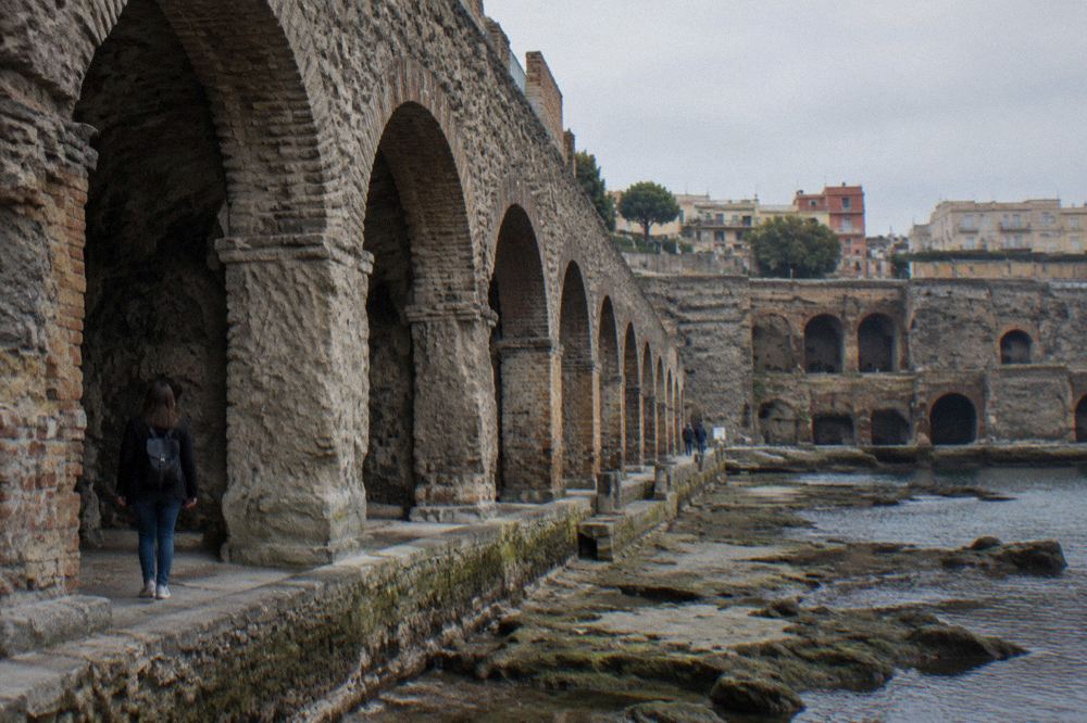 Stone arch and dark vaulted interior of a Herculaneum boat shed chamber