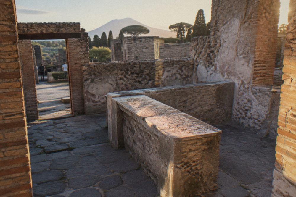 Ancient stone doorway of a Roman house opening onto a walled garden in Pompeii
