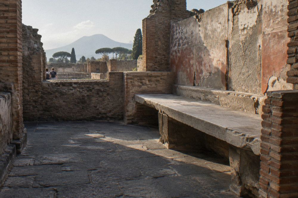 Faded fresco decoration on the plastered wall of a Roman house in Pompeii