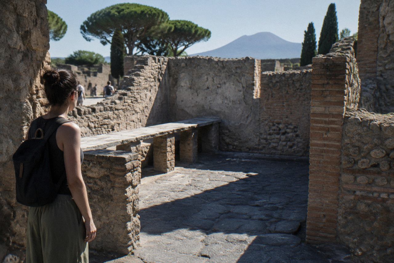 Ancient stone doorway of a Roman house opening onto a walled garden in Pompeii