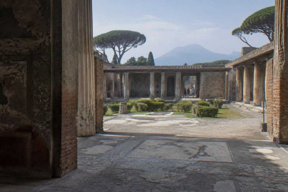 A wide colonnaded garden courtyard of an ancient Roman house with low stone columns