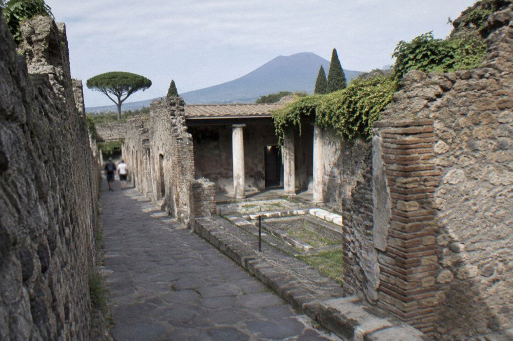 Ancient stone doorway of a Roman house on a quiet excavated street in Pompeii