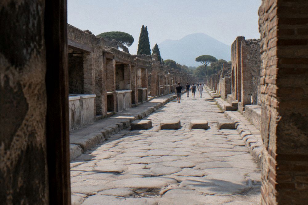 Wide view across the excavated ancient city of Pompeii with Vesuvius on the horizon