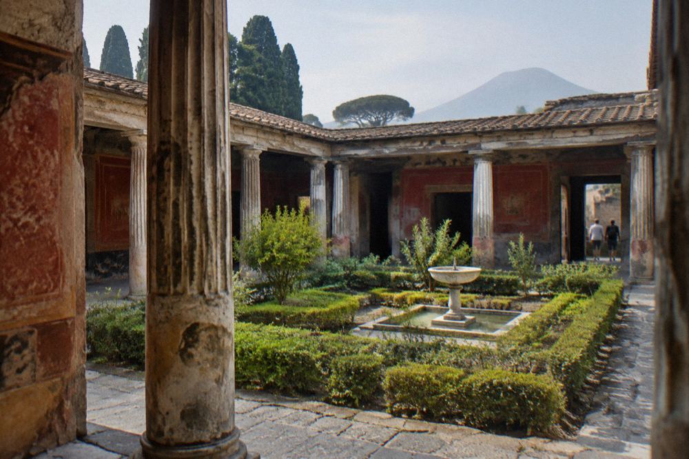 Ancient stone street in Pompeii with worn paving stones and ruined walls