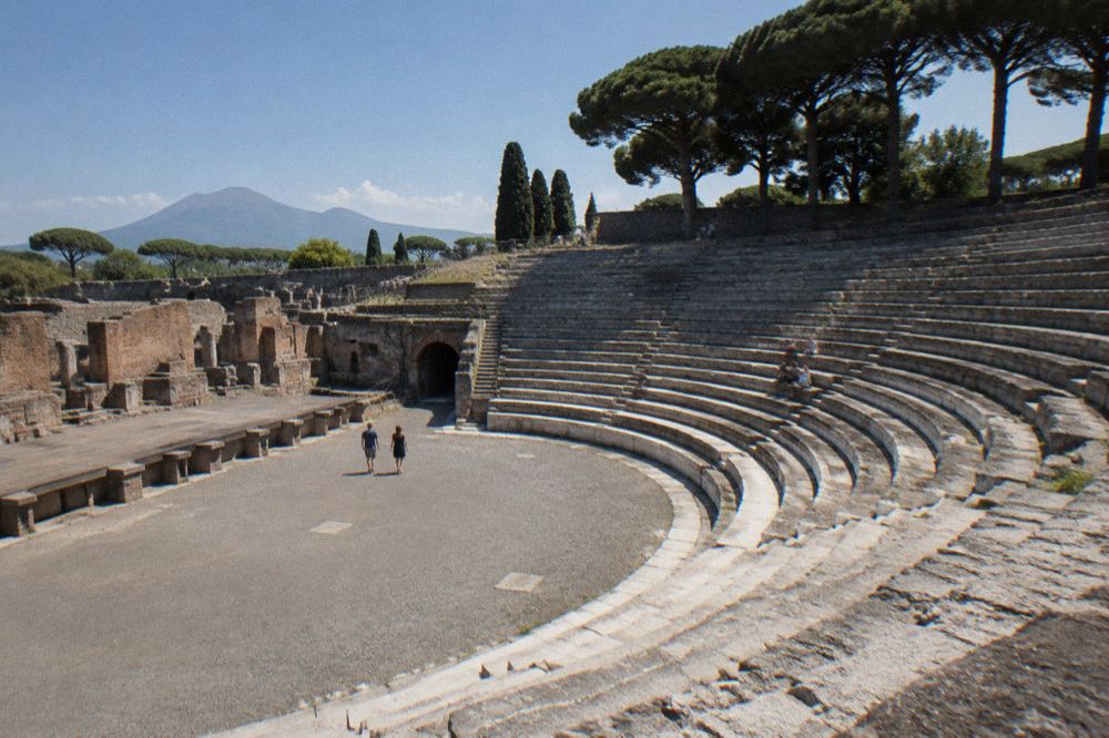 An ancient stone stage seen from high in the seating banks