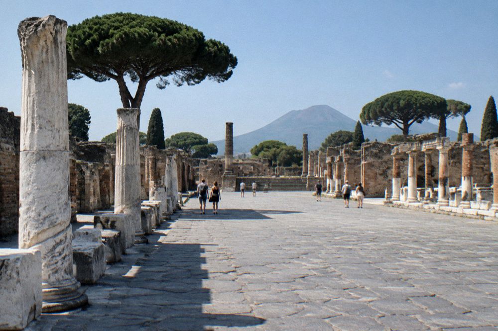 The Vesuvius cone seen from the ruins of Pompeii with ancient walls in the foreground