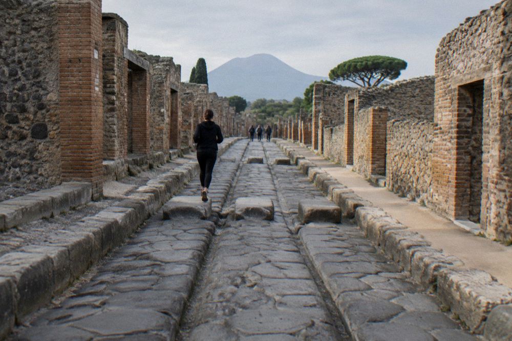 A tour group walking the crater rim of Vesuvius in late afternoon light