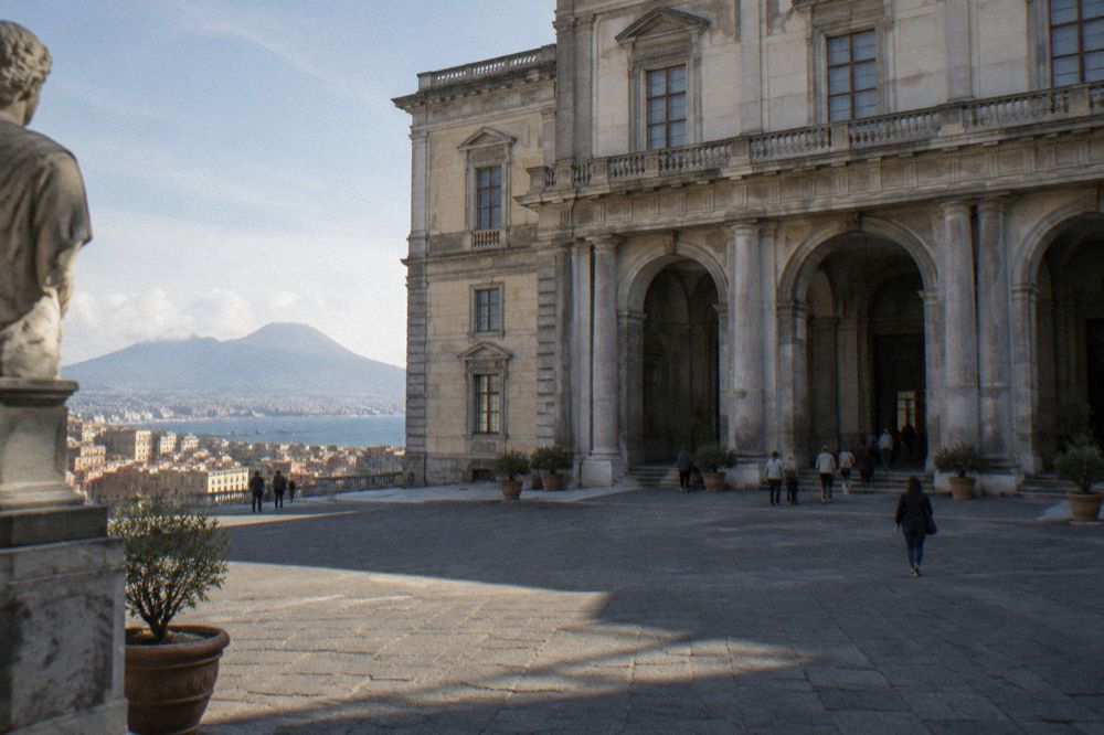 Rows of marble busts and statues of Roman figures along a brightly lit museum corridor