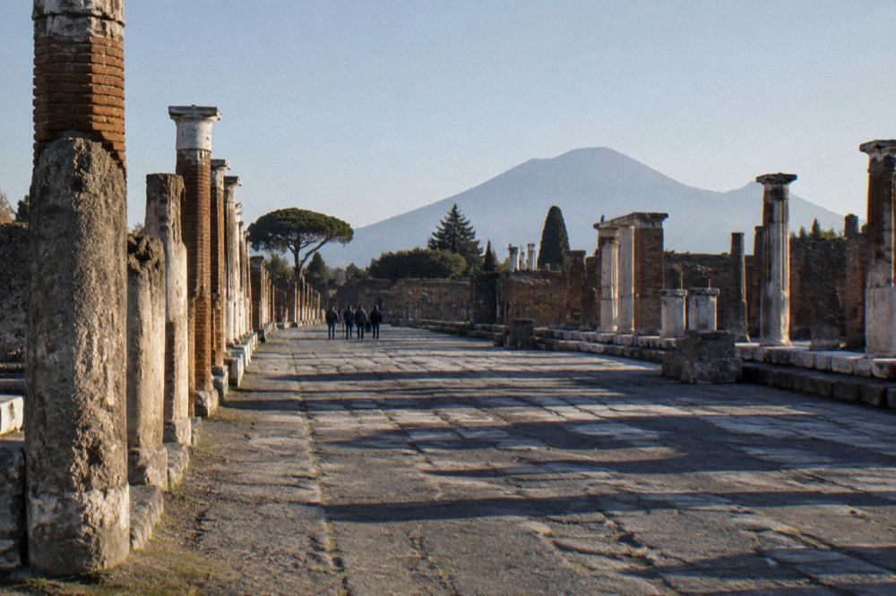 A smooth paved accessibility route through the ancient city toward the amphitheatre entrance