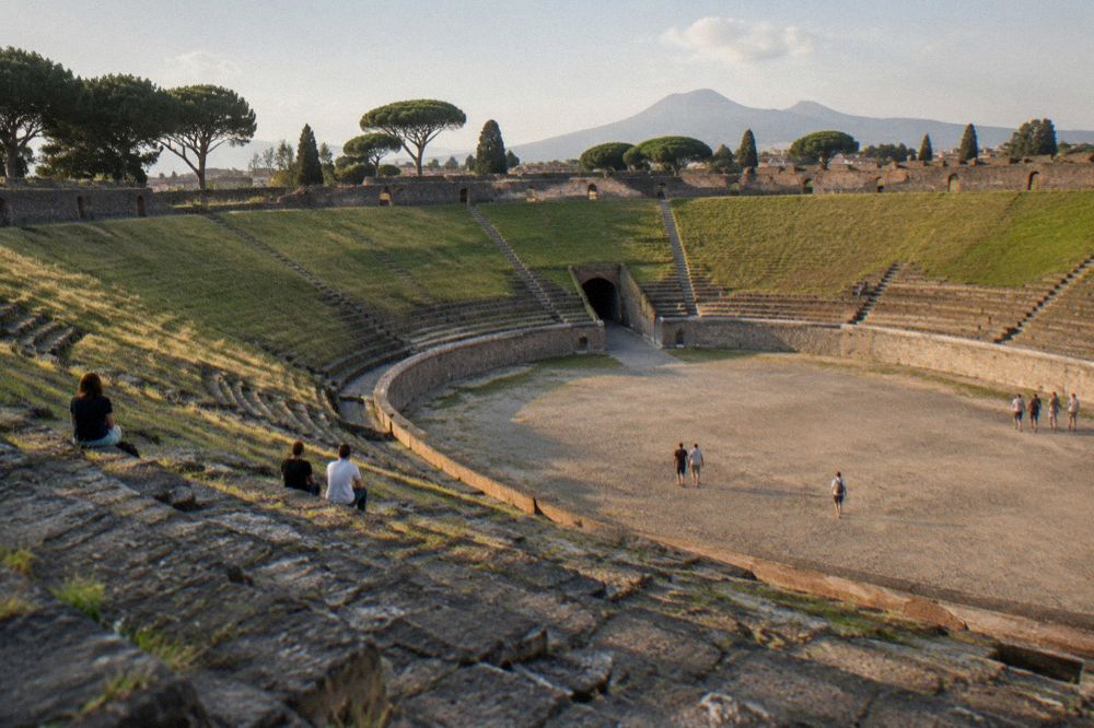 Sunlit ancient Roman street with Mount Vesuvius rising in the background