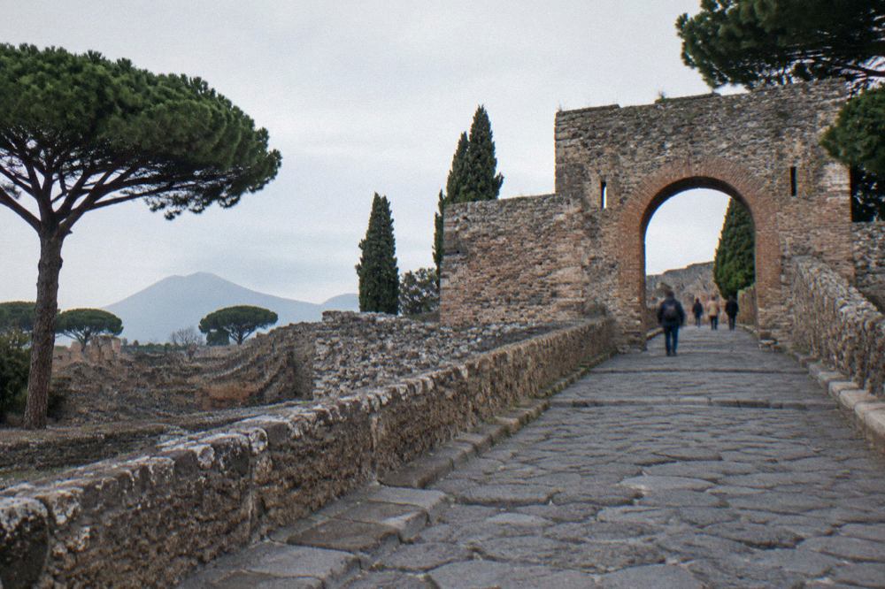 Ancient stone gate passage of Porta Marina at Pompeii with worn basalt road surface