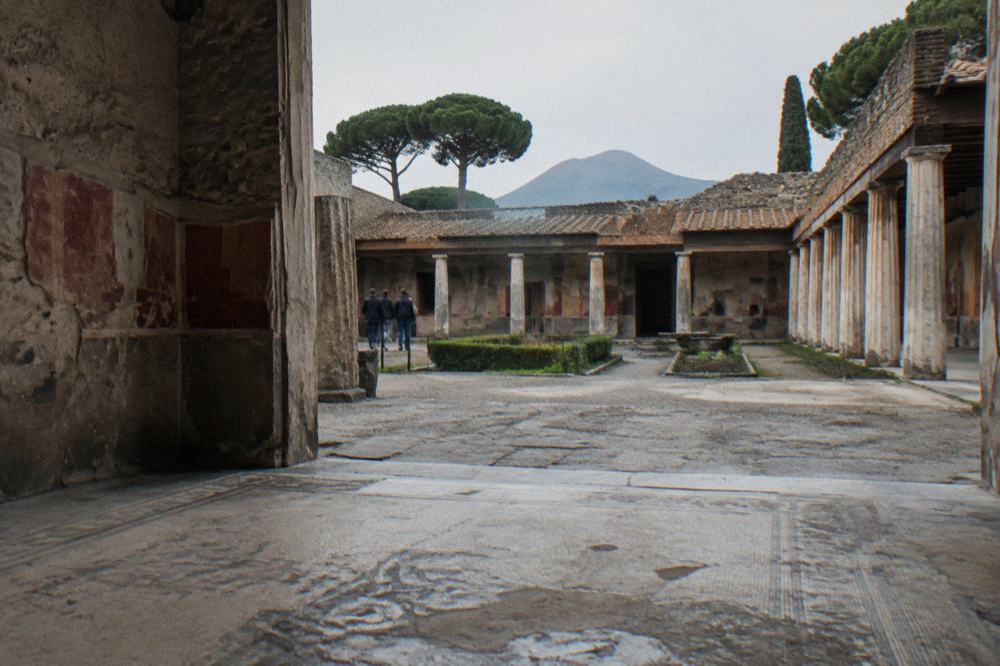 The ancient stone street and walls of Pompeii under a bright sky