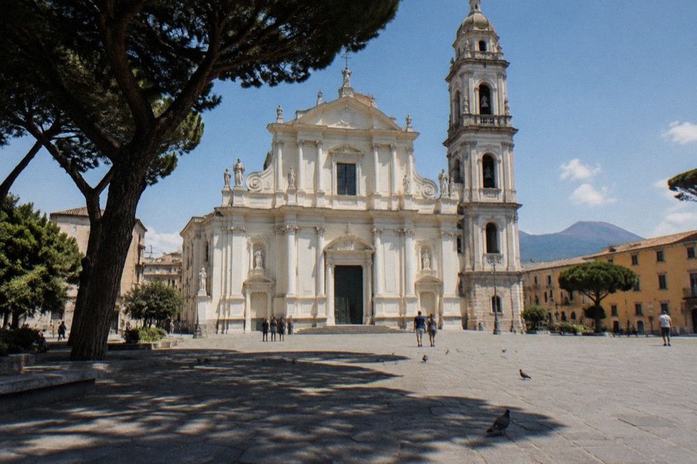 Pilgrims and visitors walking on the square in front of the Sanctuary of Pompei