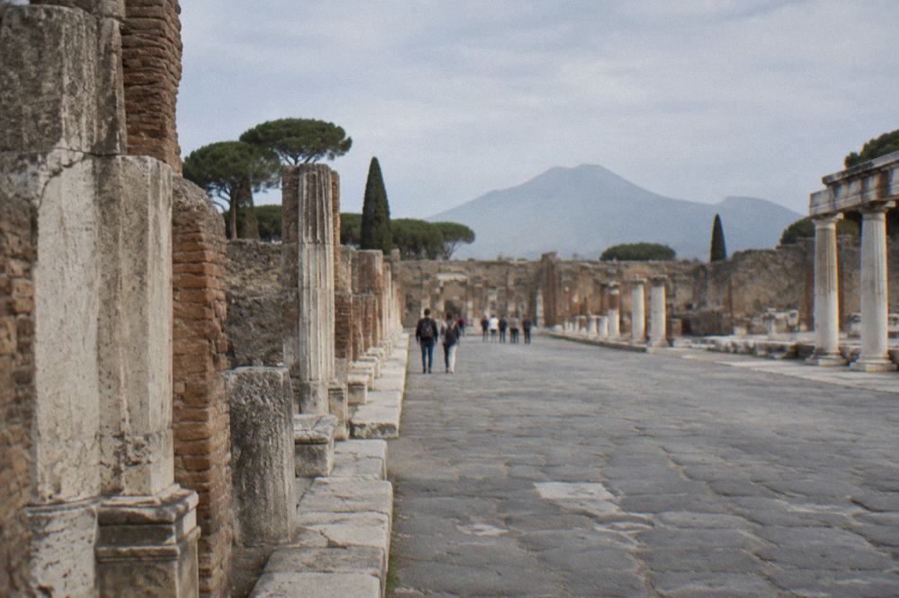 Long roofed portico of a Roman villa running along a green slope