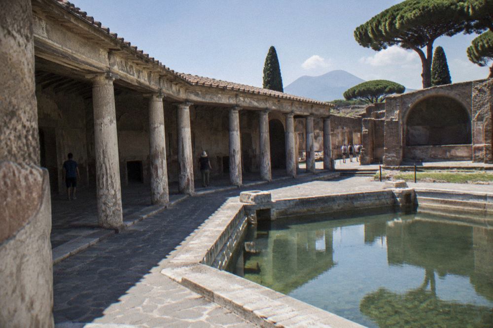 Ancient stone bathing rooms of the Stabian Baths in Pompeii under open sky
