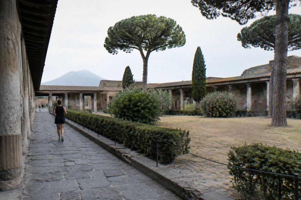 Worn stone street outside the bath complex with the volcano cone in the far distance