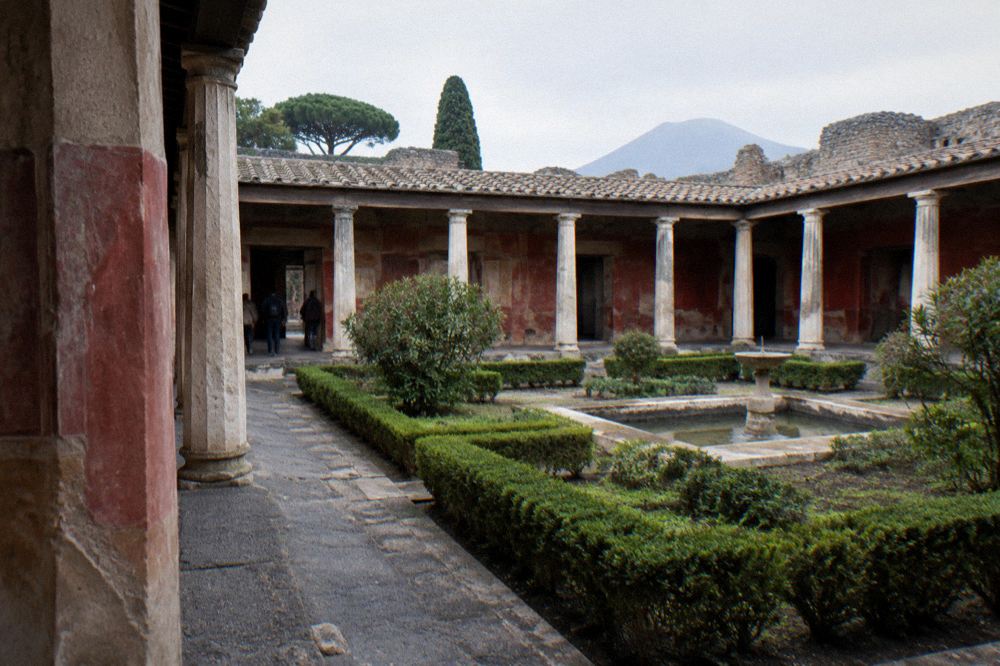 A wide view over ruined walls and distant mountain slopes from inside the ancient city