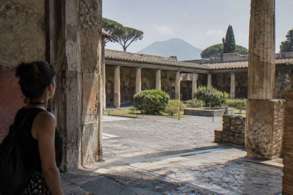 Long rectangular ancient swimming pool bordered by column bases in an excavated villa garden