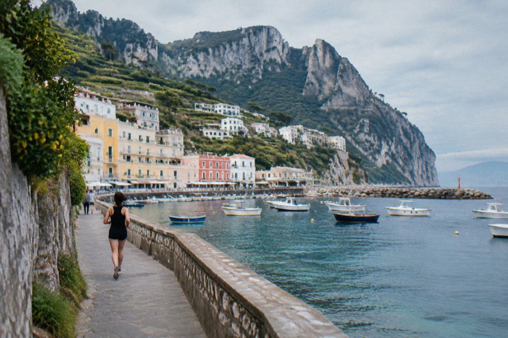 Cliffside houses above a small marina on an island in the Bay of Naples